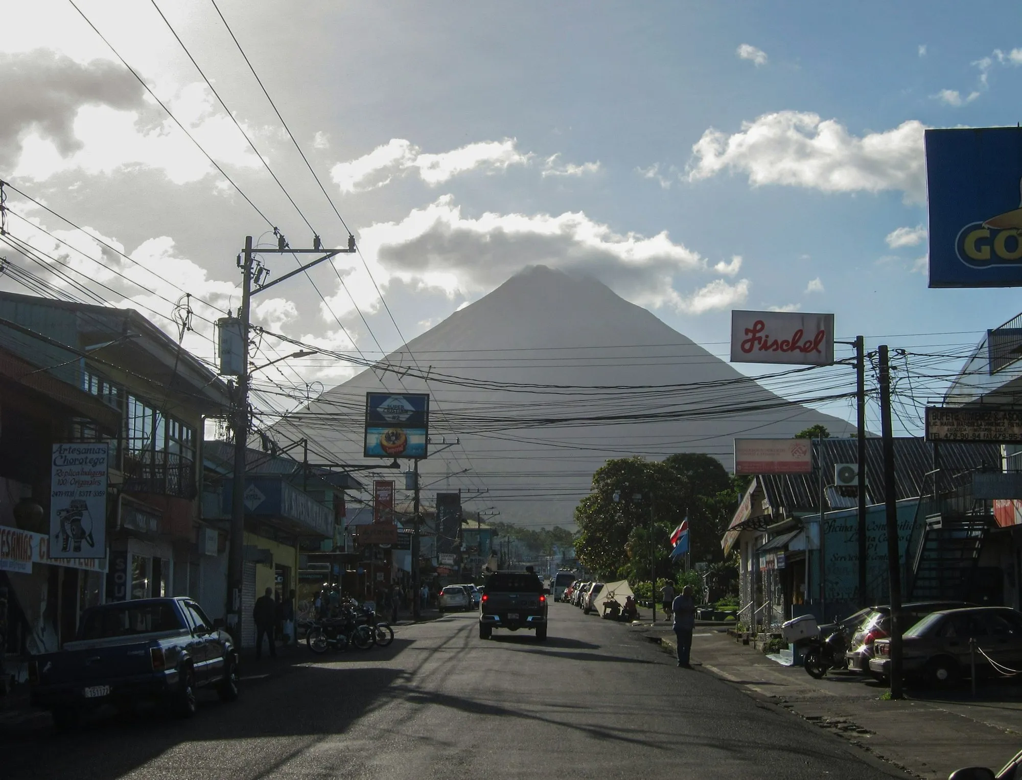 A street in La Fortuna with Arenal Volcano rising behind the town